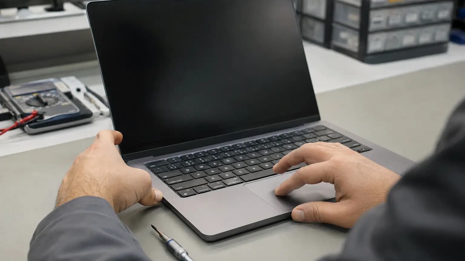 Technician diagnosing a laptop touchpad that is not working