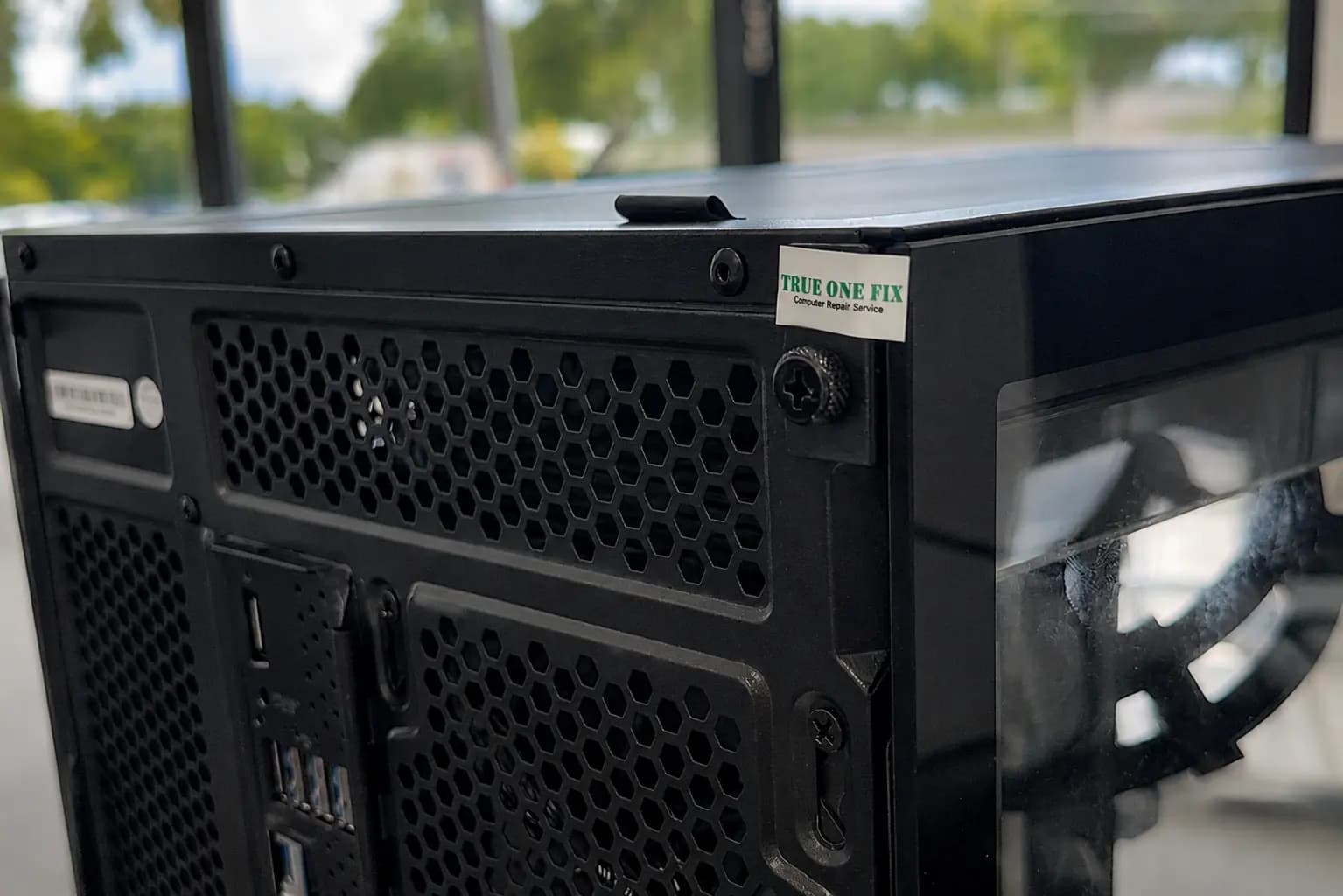 True One Fix tamper-evident warranty seal protecting a repaired desktop computer enclosure